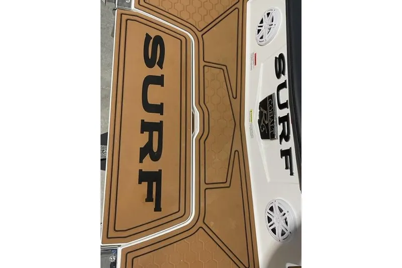 Slide: The Image of 2023 Cobalt R6 Surf boat deck with "SURF" branding and speakers. - 4