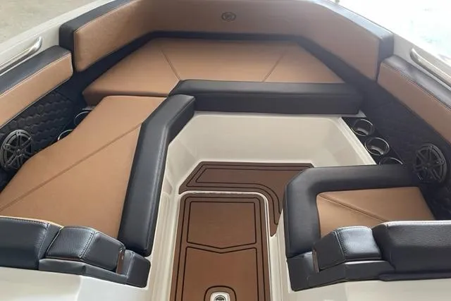 Slide: The Image of 2023 Cobalt R6 Surf boat interior with brown and black seating. - 5
