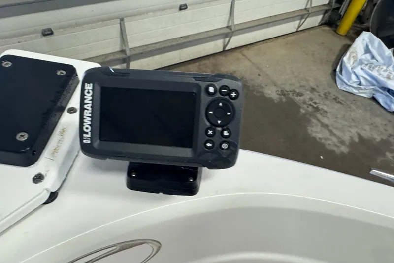 Slide: The Image of Lowrance marine GPS device on 2023 Tahoe 200 S boat dashboard. - 13