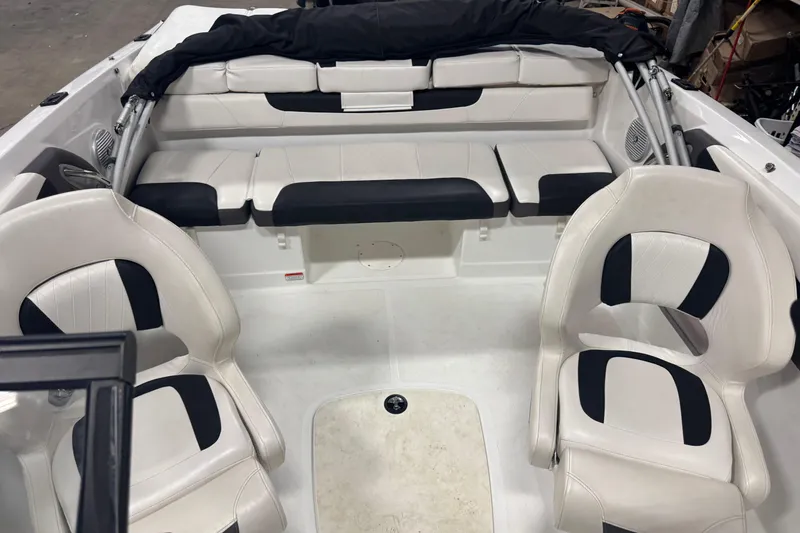 Slide: The Image of 2023 Tahoe 200 S boat interior with white and black seating arrangement. - 15