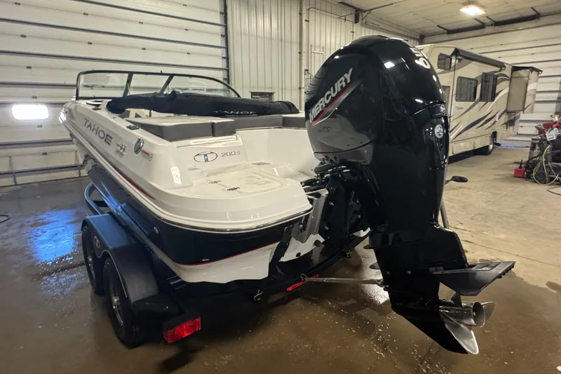 Slide: The Image of 2023 Tahoe 200 S boat with Mercury outboard motor in a garage. - 3