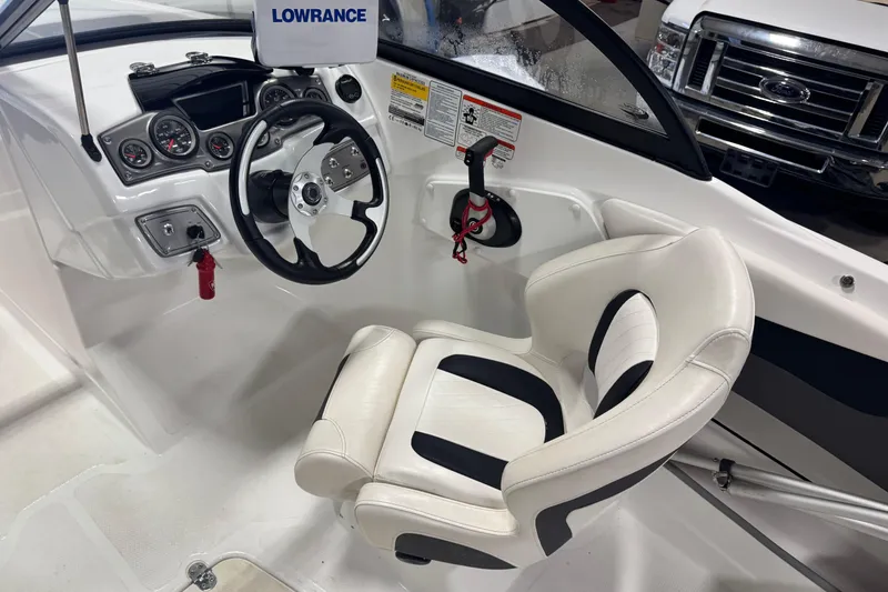 Slide: The Image of Interior of 2023 Tahoe 200 S boat with steering wheel and captain's chair. - 5