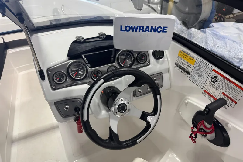 Slide: The Image of Cockpit of 2023 Tahoe 200 S boat with Lowrance navigation system and steering wheel. - 6