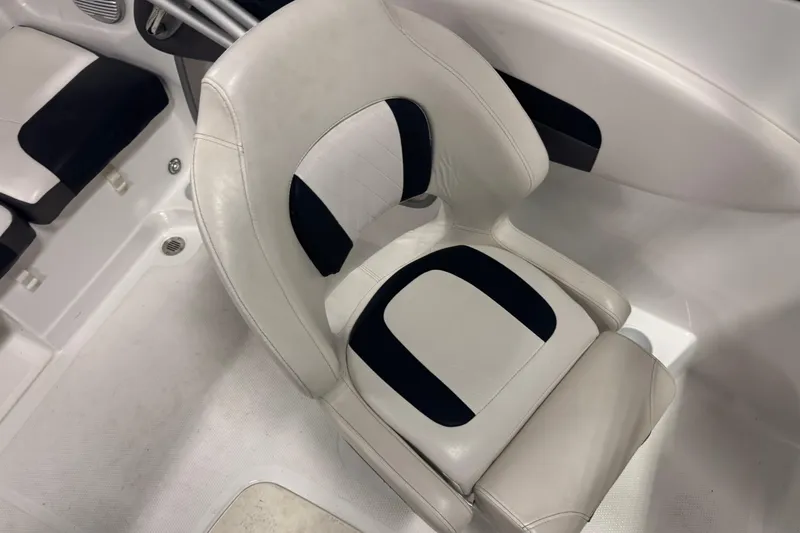 Slide: The Image of 2023 Tahoe 200 S boat interior with white and black cushioned seating. - 9