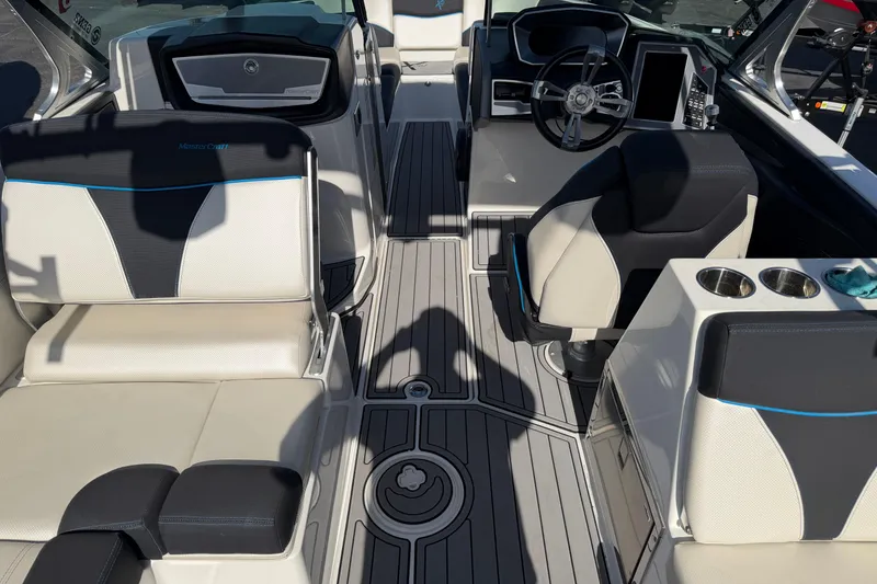 Slide: The Image of Interior of a 2018 MasterCraft X26 boat with modern seating and steering wheel. - 11