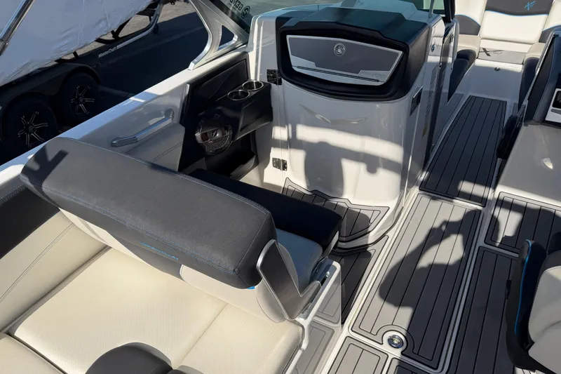 Slide: The Image of 2018 MasterCraft X26 boat interior with sleek seating and modern dashboard design. - 12