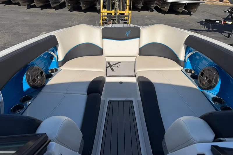 Slide: The Image of 2018 MasterCraft X26 boat interior with blue accents and speaker system. - 14