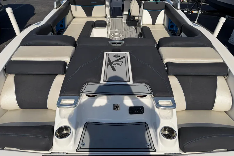 Slide: The Image of 2018 MasterCraft X26 boat interior with cushioned seating and sleek design. - 7