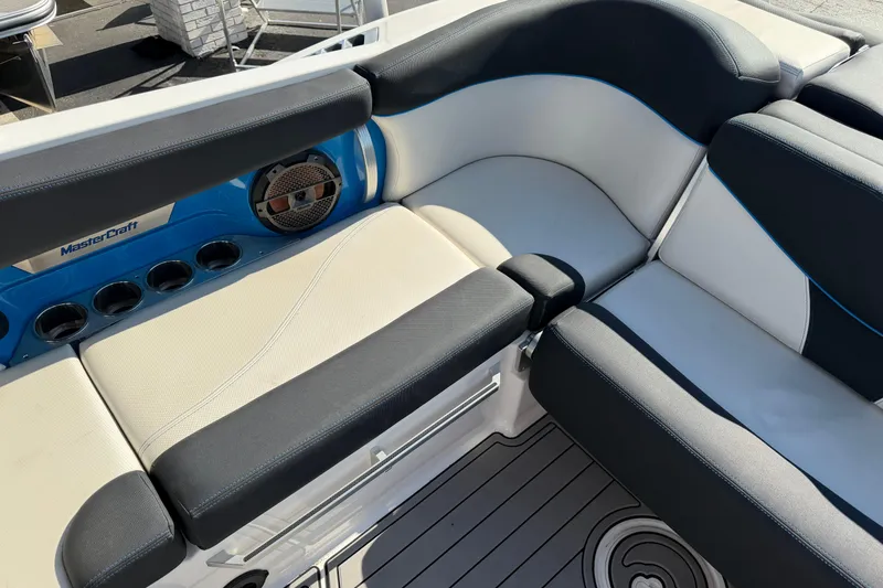 Slide: The Image of 2018 MasterCraft X26 boat interior with cushioned seating and built-in speaker system. - 9