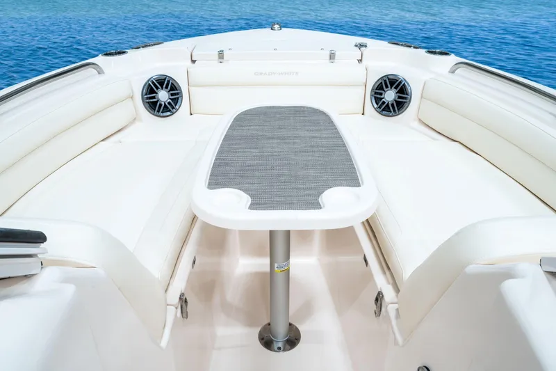 Slide: The Image of 2025 Grady-White Freedom 215 boat interior with seating and outboard motor on calm water. - 10