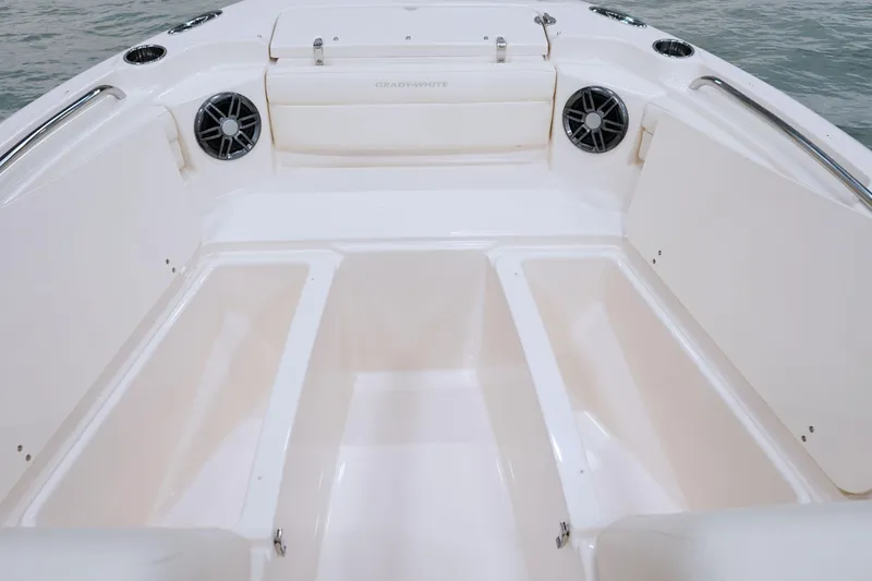 Slide: The Image of 2025 Grady-White Freedom 215 boat interior with open storage, on calm water. - 11
