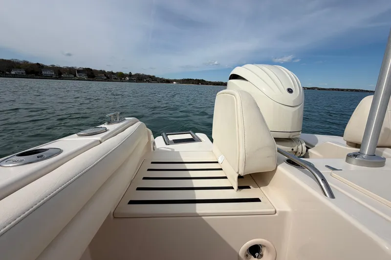 Slide: The Image of 2025 Grady-White Freedom 215 boat on water, showcasing seating and engine. - 13