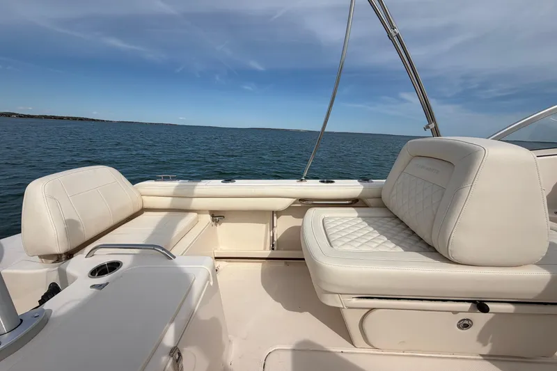 Slide: The Image of 2025 Grady-White Freedom 215 boat interior with luxurious seating on open water. - 14