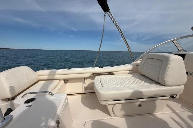 Slide: The Image of 2025 Grady-White Freedom 215 boat interior with white seating, ocean view. - 15