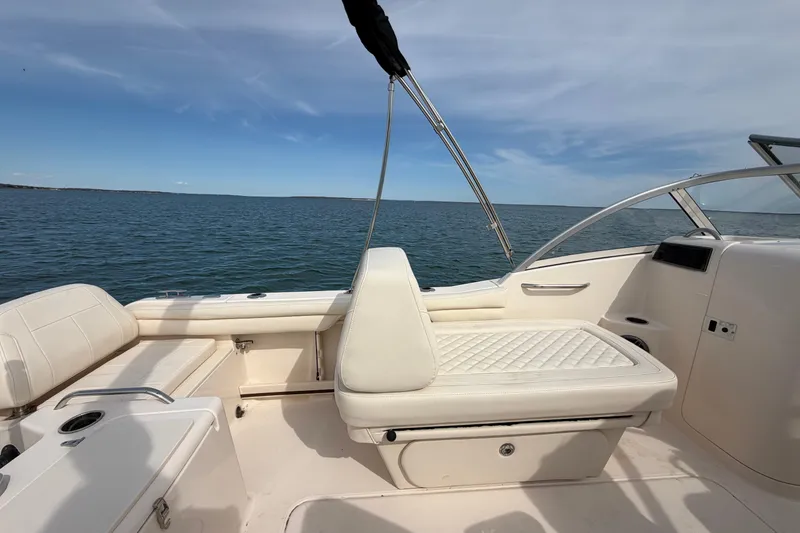 Slide: The Image of 2025 Grady-White Freedom 215 boat interior with white seating, ocean view. - 16