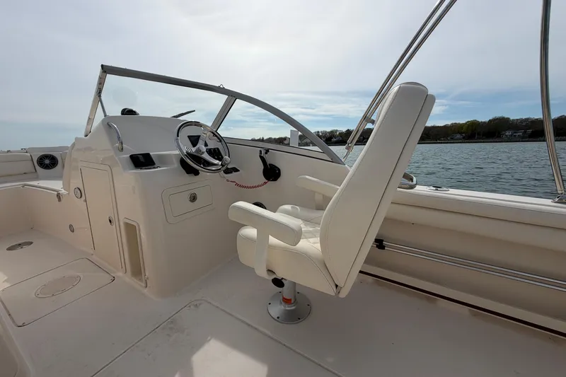 Slide: The Image of 2025 Grady-White Freedom 215 boat interior with steering wheel and captain's chair. - 17