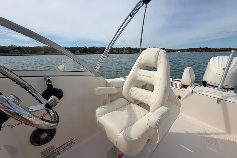 Slide: The Image of 2025 Grady-White Freedom 215 boat interior with steering wheel and comfortable seating. - 18