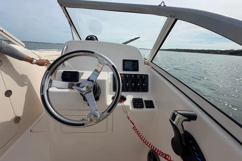 Slide: The Image of Steering console of 2025 Grady-White Freedom 215 boat on open water. - 19