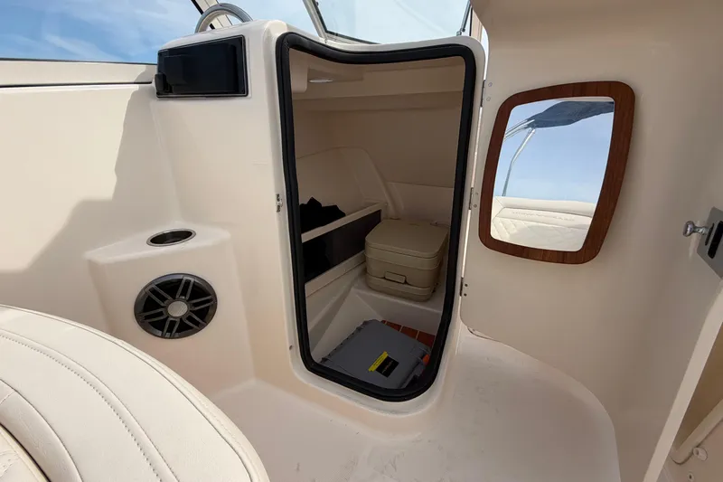 Slide: The Image of Interior cabin of 2025 Grady-White Freedom 215 boat, featuring seating and storage. - 21