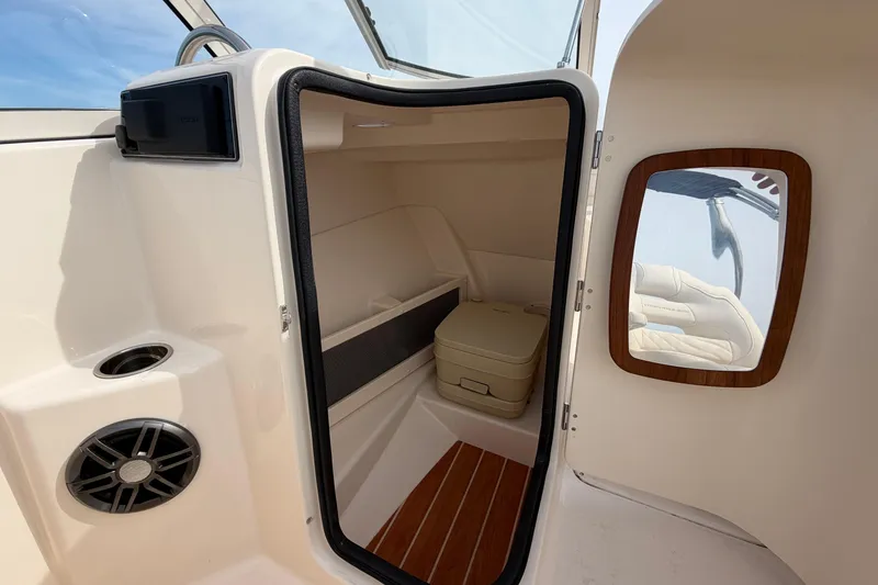 Slide: The Image of 2025 Grady-White Freedom 215 boat interior with storage and mirror. - 22