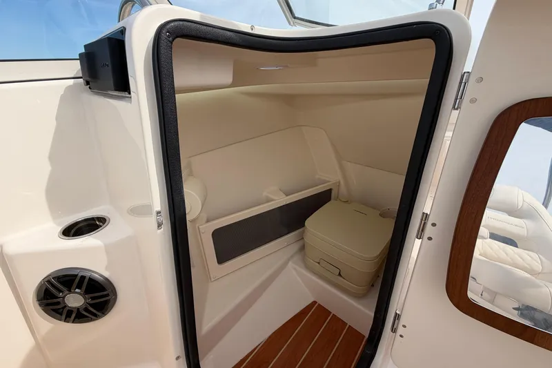 Slide: The Image of 2025 Grady-White Freedom 215 boat interior with compact cabin and seating. - 23
