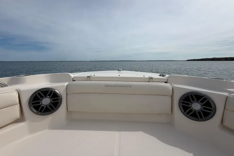 Slide: The Image of 2025 Grady-White Freedom 215 boat interior with speakers, overlooking calm waters. - 25