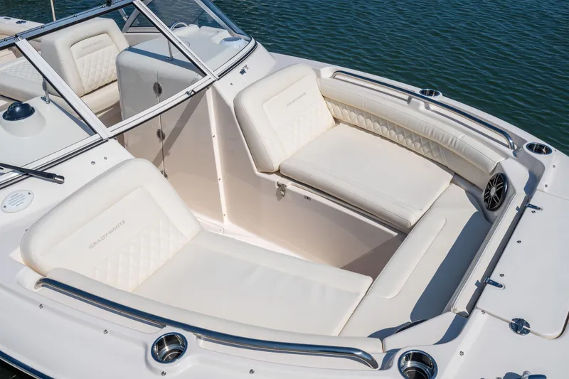 Slide: The Image of 2025 Grady-White Freedom 215 boat on water, featuring spacious seating and modern controls. - 8