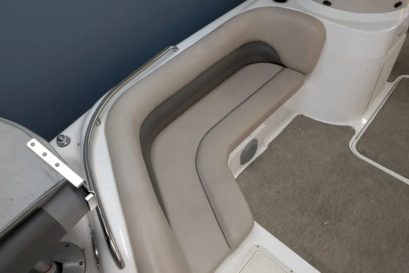 Slide: The Image of 2013 Hurricane SunDeck Sport 201 IO boat interior with beige seating and carpeted flooring. - 3