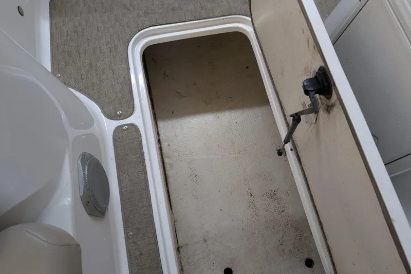 Slide: The Image of Open storage compartment on 2013 Hurricane SunDeck Sport 201 IO boat interior. - 8