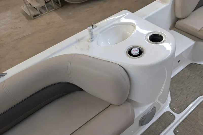 Slide: The Image of 2013 Hurricane SunDeck Sport 201 IO boat interior with beige seating and cup holders. - 9