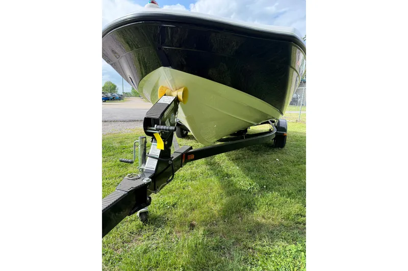 Slide: The Image of 2016 Yamaha Boats SX190 on trailer, parked on grass under cloudy sky. - 12