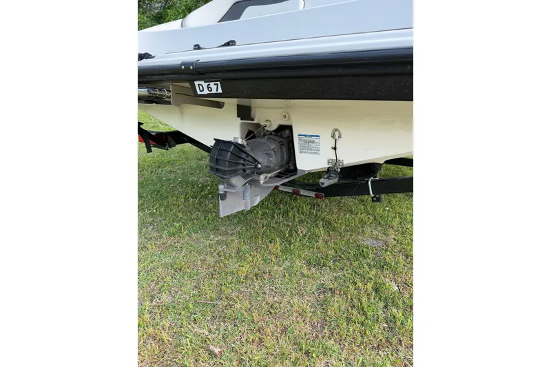 Slide: The Image of 2016 Yamaha Boats SX190 jet drive on grass, showcasing rear view and trailer. - 4