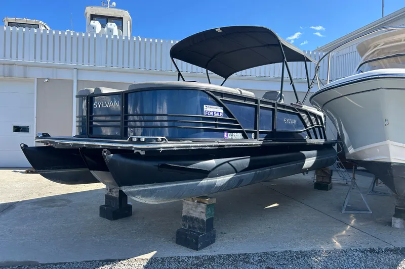 The Image of 2023 Sylva S3 pontoon boat for sale, displayed outdoors on blocks. - 1