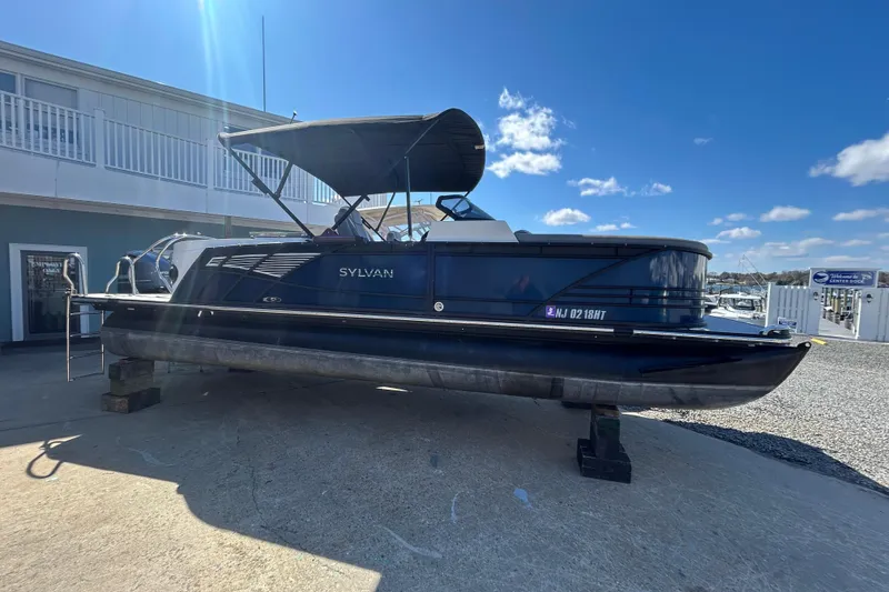 Slide: The Image of 2023 Sylva S3 pontoon boat on display under clear blue sky. - 3