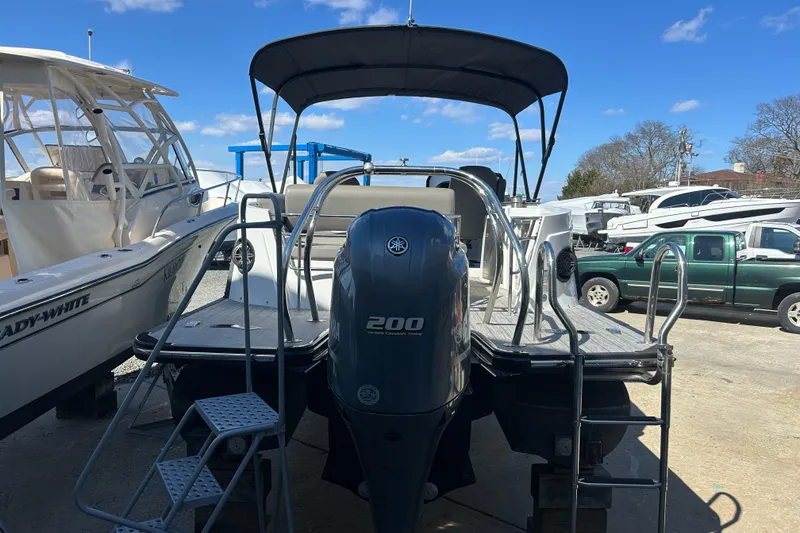 Slide: The Image of 2023 Sylva S3 boat with Yamaha 200 engine, docked under clear blue sky. - 4