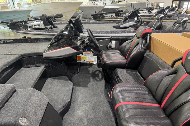 Slide: The Image of 2026 Skeeter ZXE20 boat interior with sleek black and red seating and modern dashboard. - 6