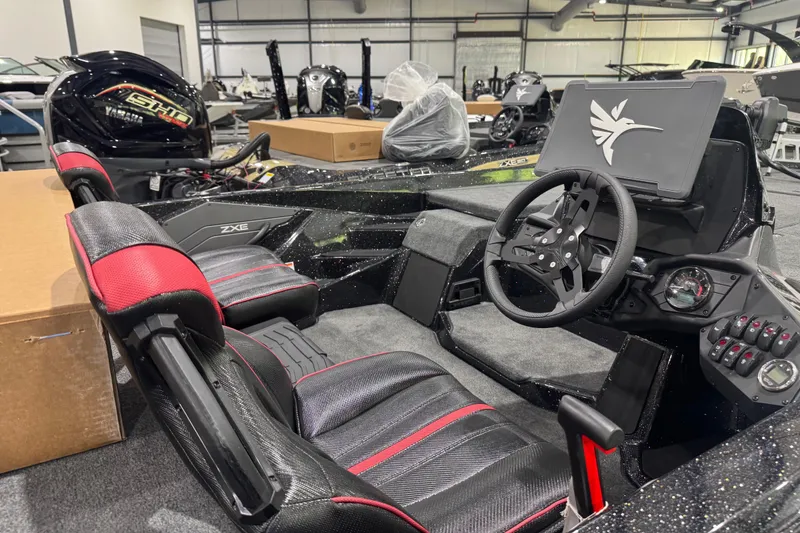 Slide: The Image of 2026 Skeeter ZXE20 boat interior with steering wheel and red-accented seats. - 9