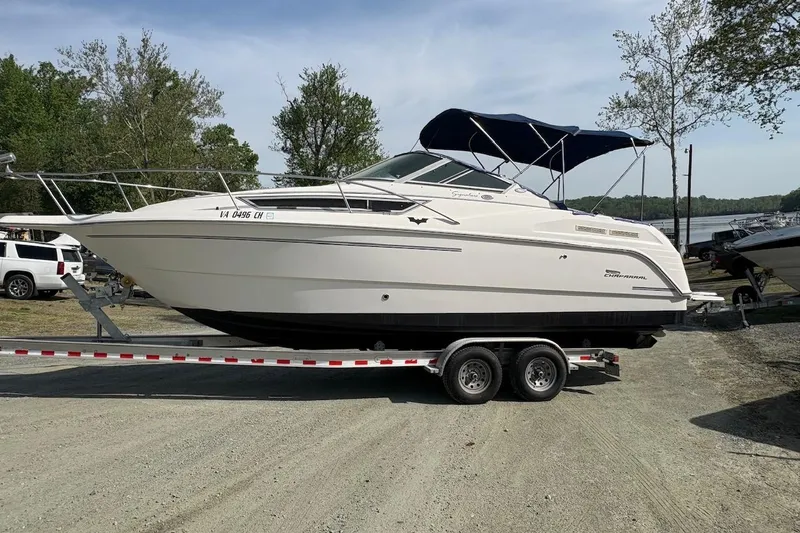 Slide: The Image of 2000 Chaparral Signature 270 boat on trailer, parked outdoors under blue sky. - 1