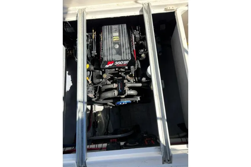 Slide: The Image of Engine compartment of a 2000 Chaparral Signature 270 boat, featuring a 350 MAG engine. - 11