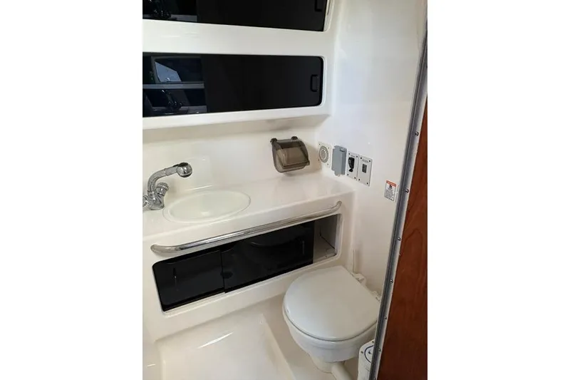 Slide: The Image of Interior cabin of 2000 Chaparral Signature 270 with blue bedding and striped pillow. - 15