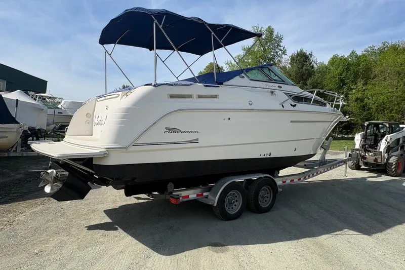 Slide: The Image of 2000 Chaparral Signature 270 boat on trailer, parked outdoors under blue sky. - 4