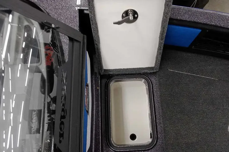 Slide: The Image of 2026 Ranger 1880MS A Pack Equipped boat storage compartment with open lid and handle. - 12