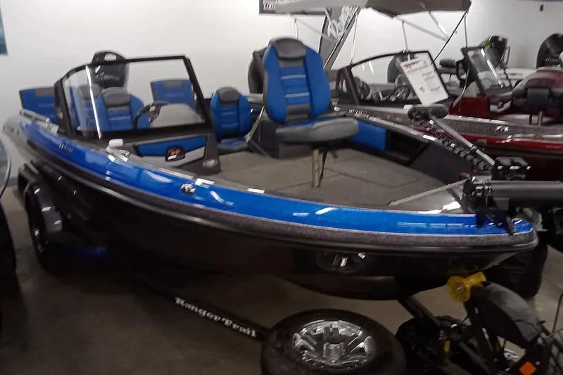Slide: The Image of 2026 Ranger 1880MS A Pack Equipped boat, blue and black, displayed indoors. - 29