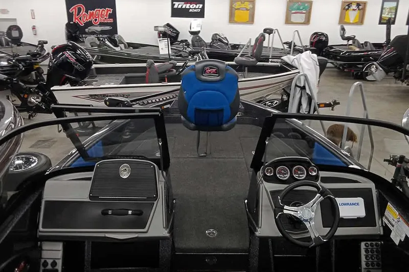 Slide: The Image of 2026 Ranger 1880MS A Pack Equipped boat interior with steering wheel and dashboard in showroom. - 8