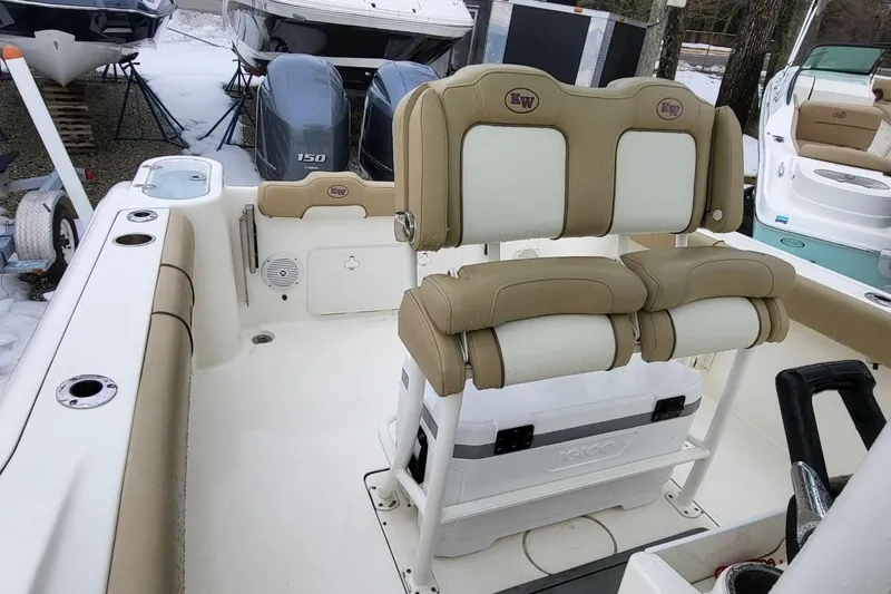 Slide: The Image of 2019 Key West 244 Center Console boat interior with dual seats and twin engines. - 11