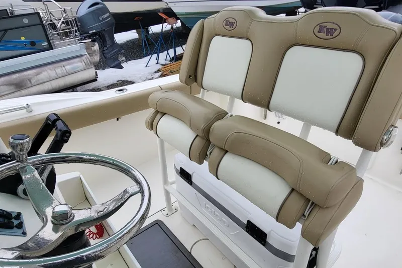 Slide: The Image of 2019 Key West 244 Center Console boat interior with steering wheel and cushioned seats. - 16