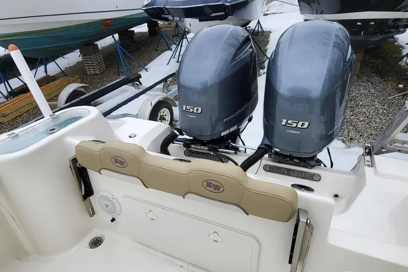 Slide: The Image of 2019 Key West 244 Center Console with twin Yamaha 150 engines in a boatyard. - 17