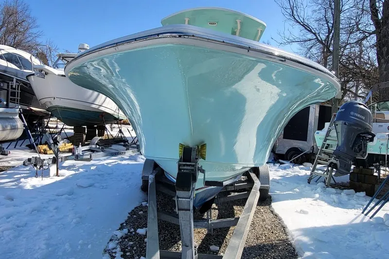 Slide: The Image of 2019 Key West 244 Center Console boat on trailer in snowy yard. - 2