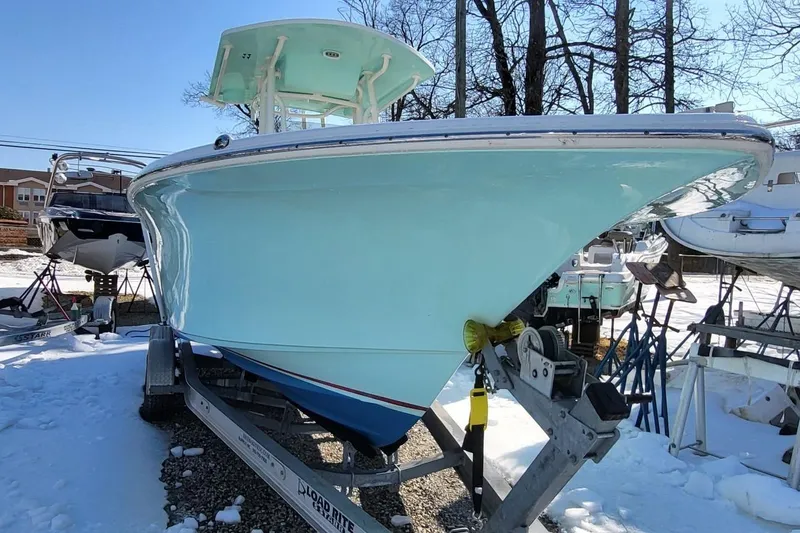 Slide: The Image of 2019 Key West 244 Center Console boat on trailer in snowy yard. - 3