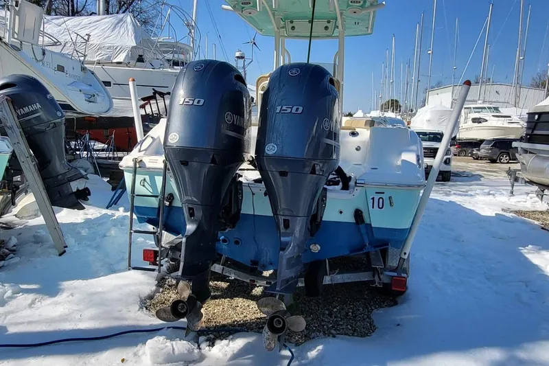 Slide: The Image of 2019 Key West 244 Center Console boat with twin Yamaha 150 engines in snowy marina. - 7
